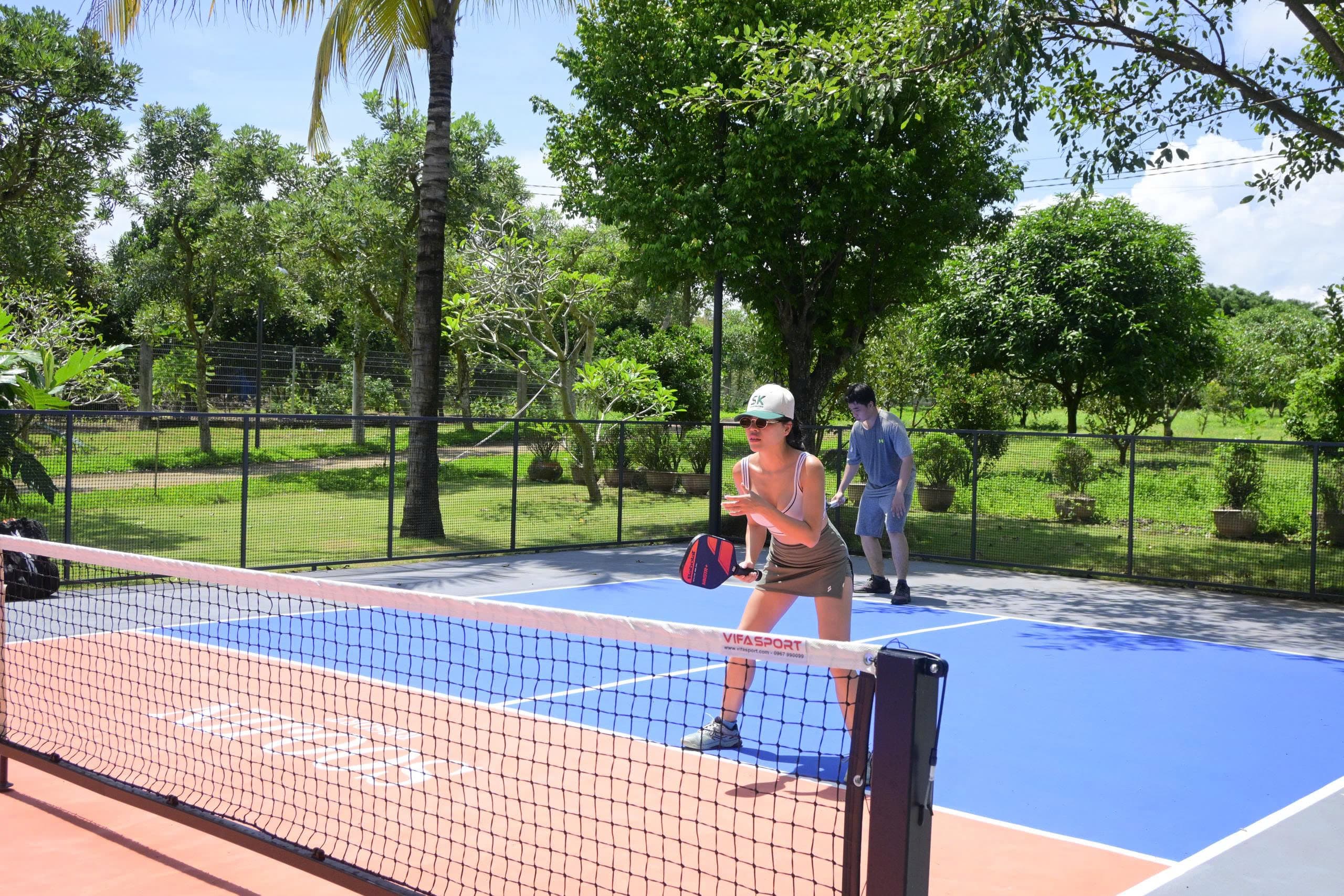 Players at the net during a pickleball game at Soojin Resort