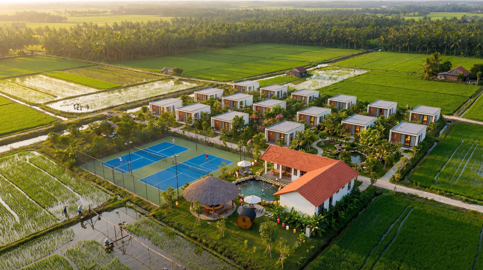 Aerial drone view of Sportkation estate in Dong Nai — pickleball courts, private cabins and orchard gardens
