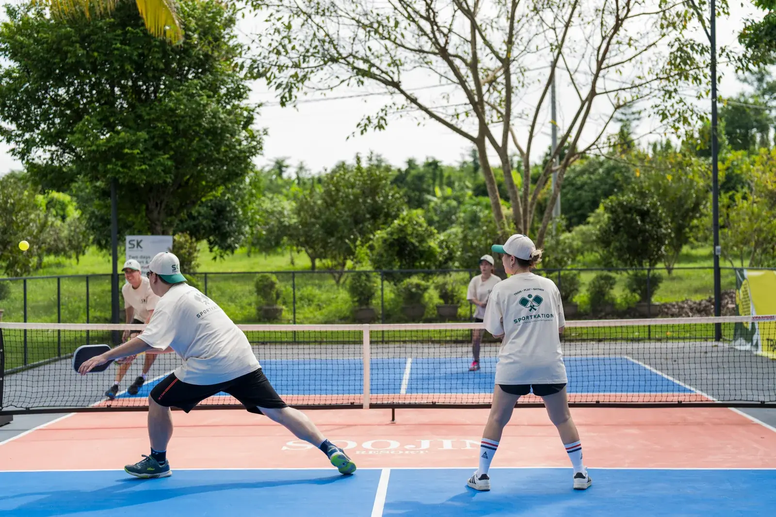 Sportkation participants playing doubles pickleball at Soojin Resort
